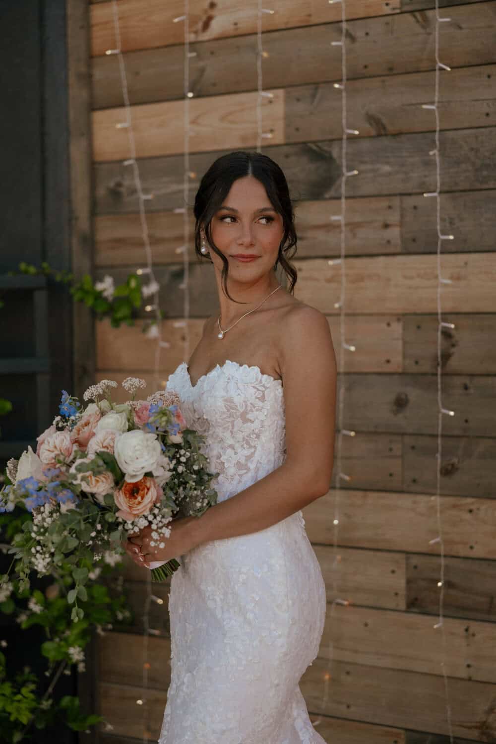 Bride holding soft pastel color bouquet on her wedding day