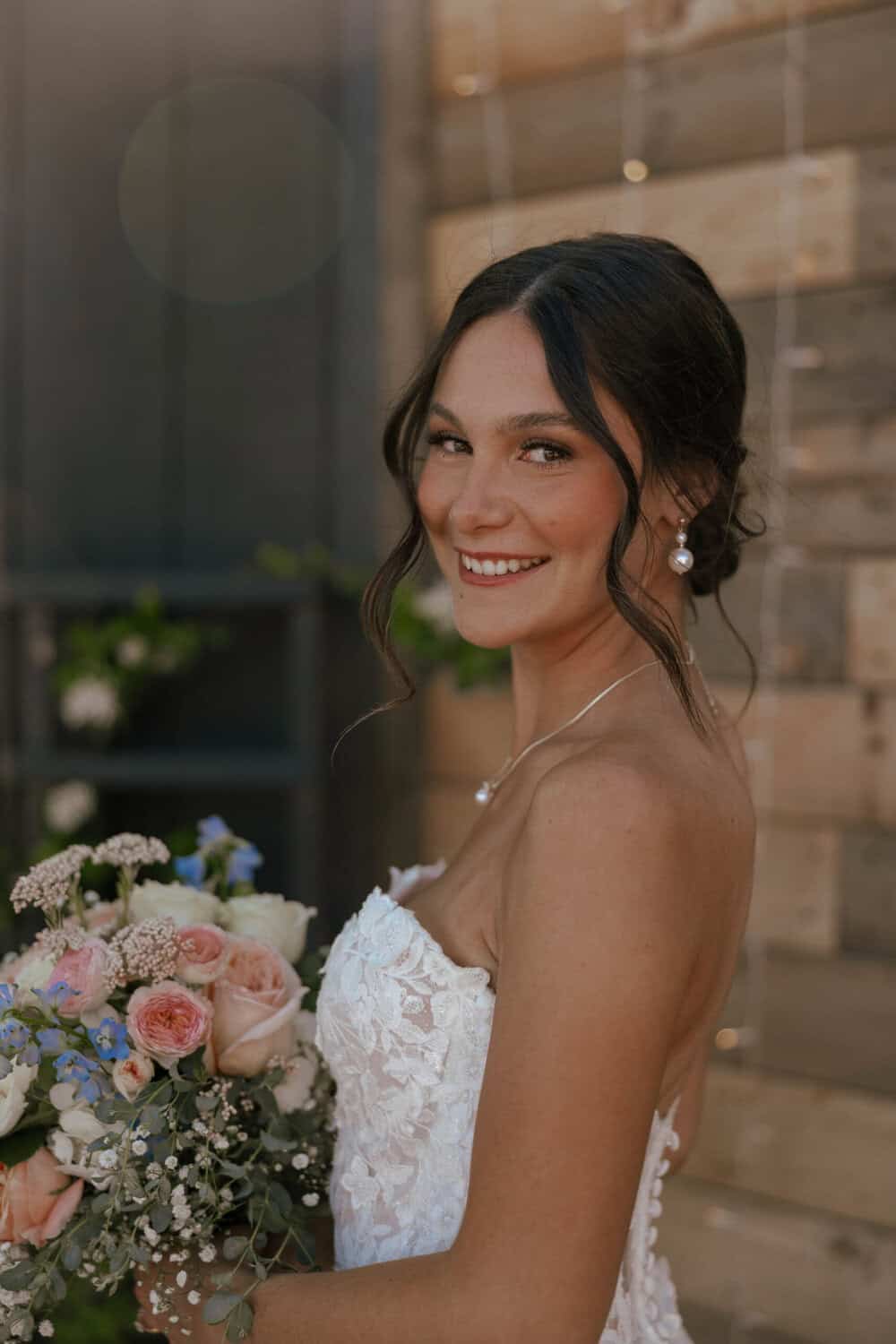 Bride holding soft pastel color bouquet on her wedding day