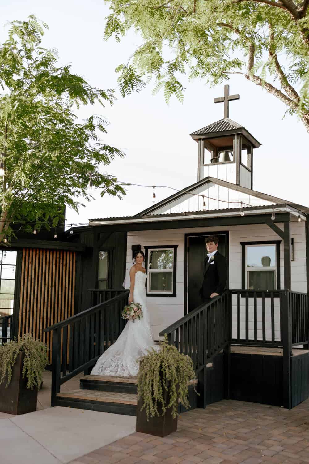 bride and groom posing on the bridal suite steps