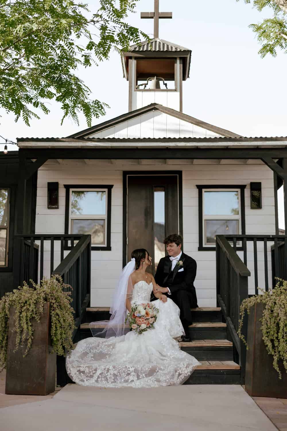 bride and groom posing on the bridal suite steps at the Venue at Chilleens
