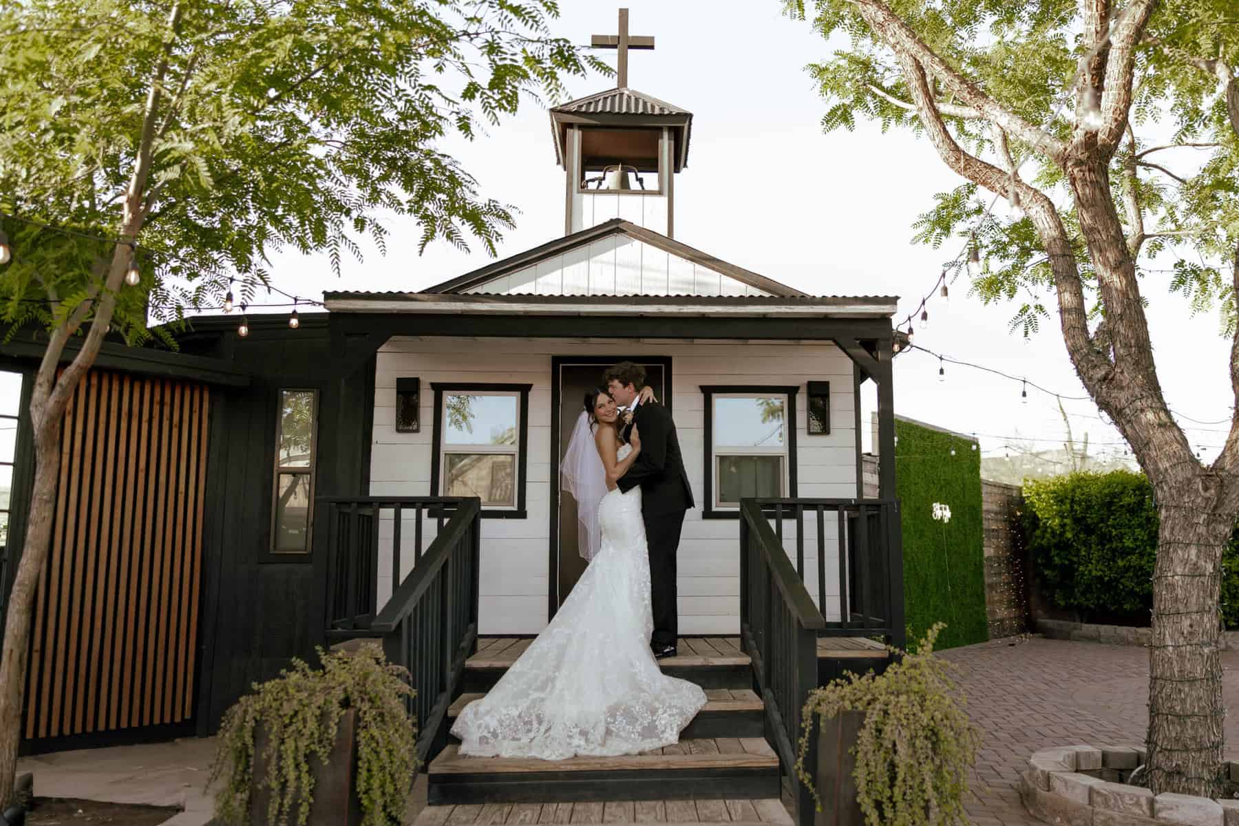 bride and groom kissing on the bridal suite steps, arizona wedding venue
